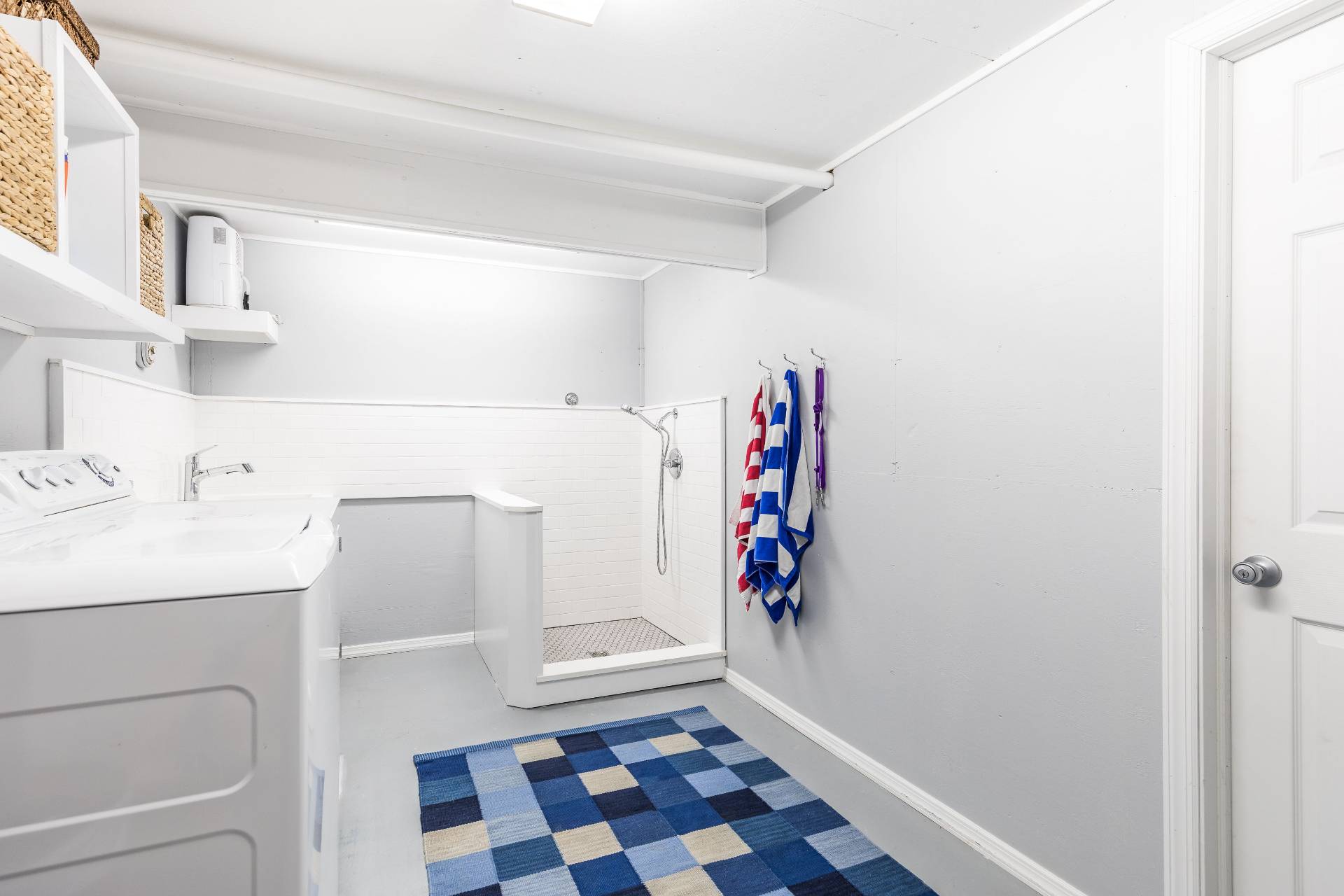 124 Ocean Road Bridgehampton, NY 11932 - Photo 23 of 27 a bathroom with a sink and a washing machine