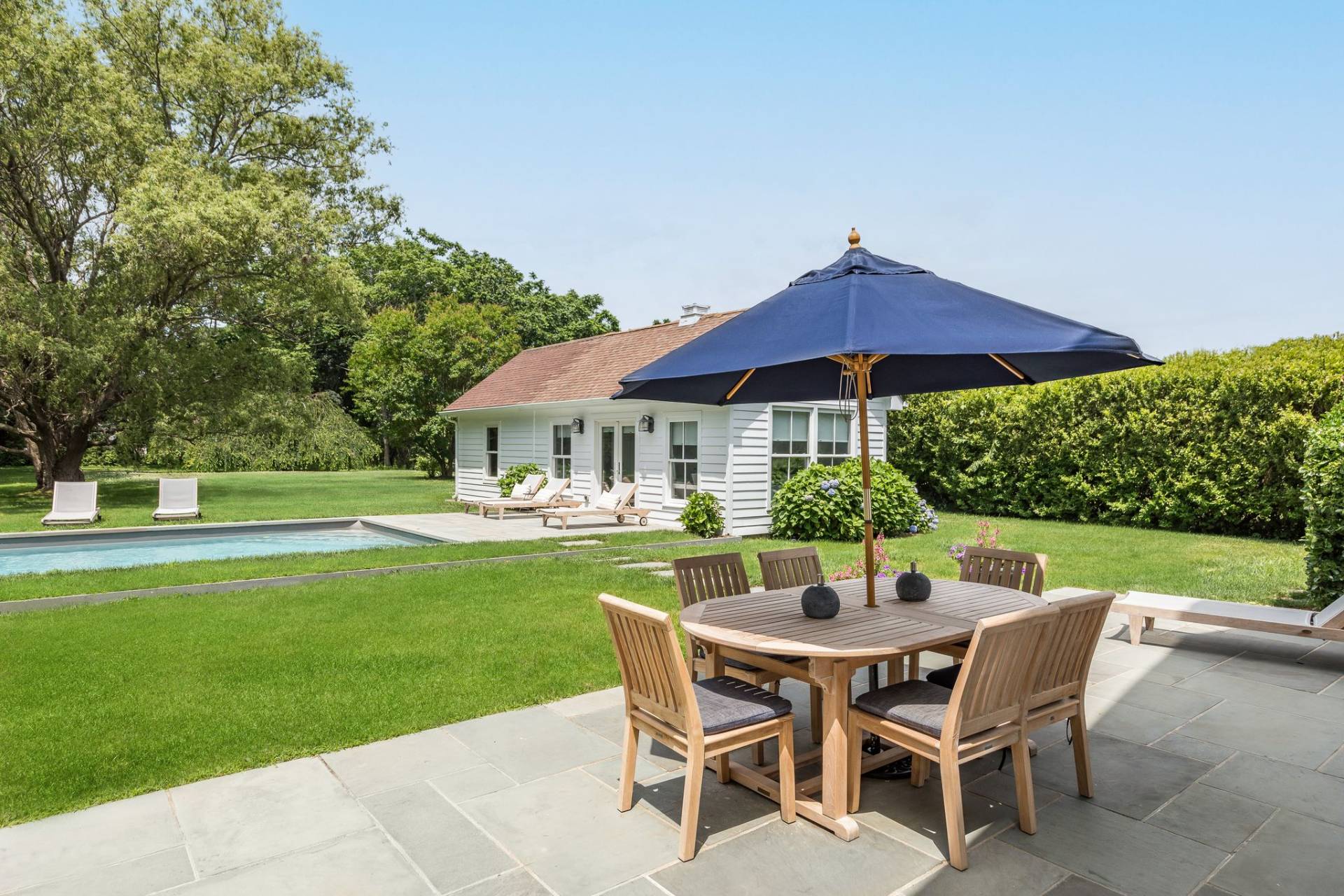 124 Ocean Road Bridgehampton, NY 11932 - Photo 6 of 27 a patio with a table and chairs