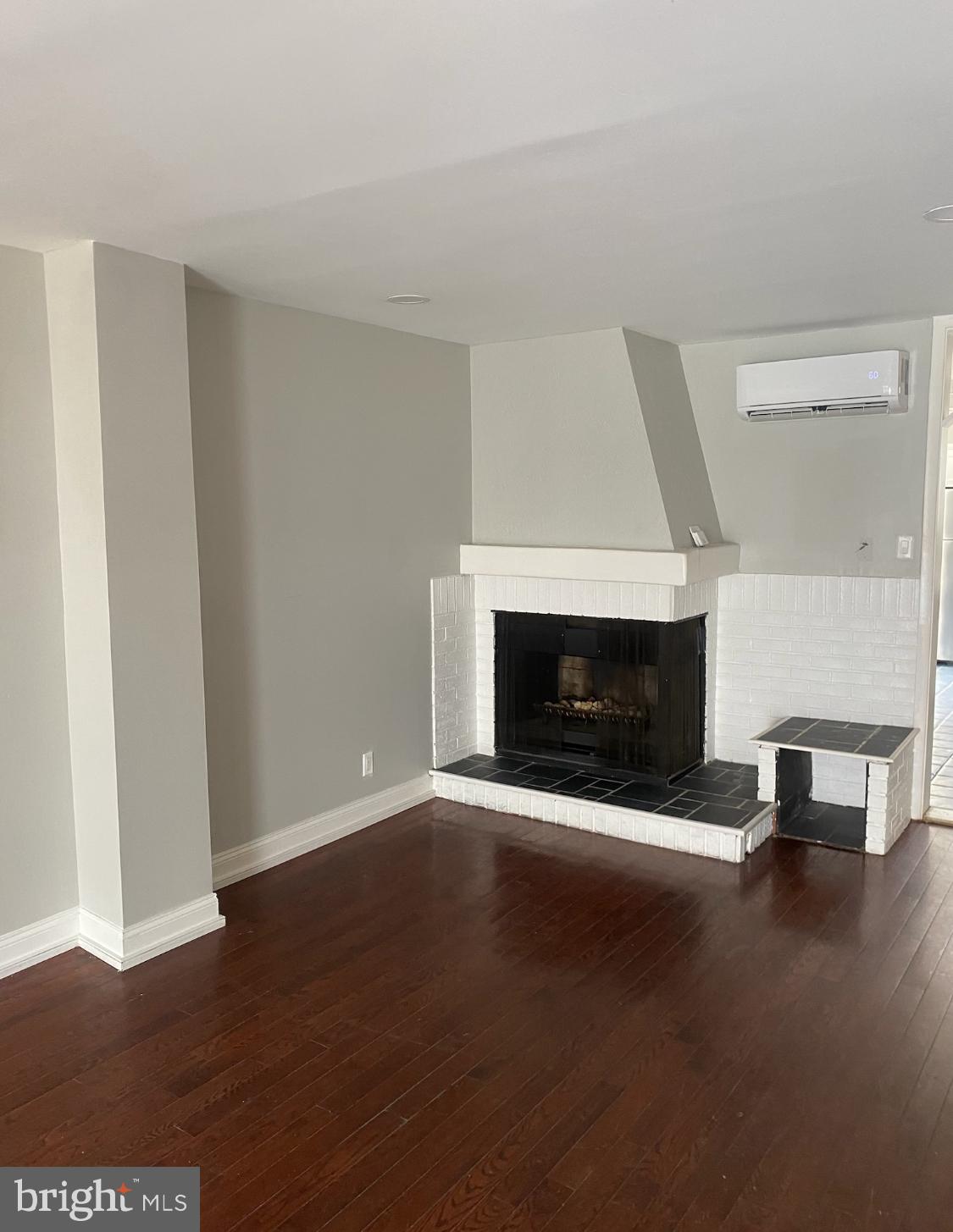 1738 Stocker Street Philadelphia, PA 19145 - Photo 2 of 8 a view of empty room with fireplace and wooden floor