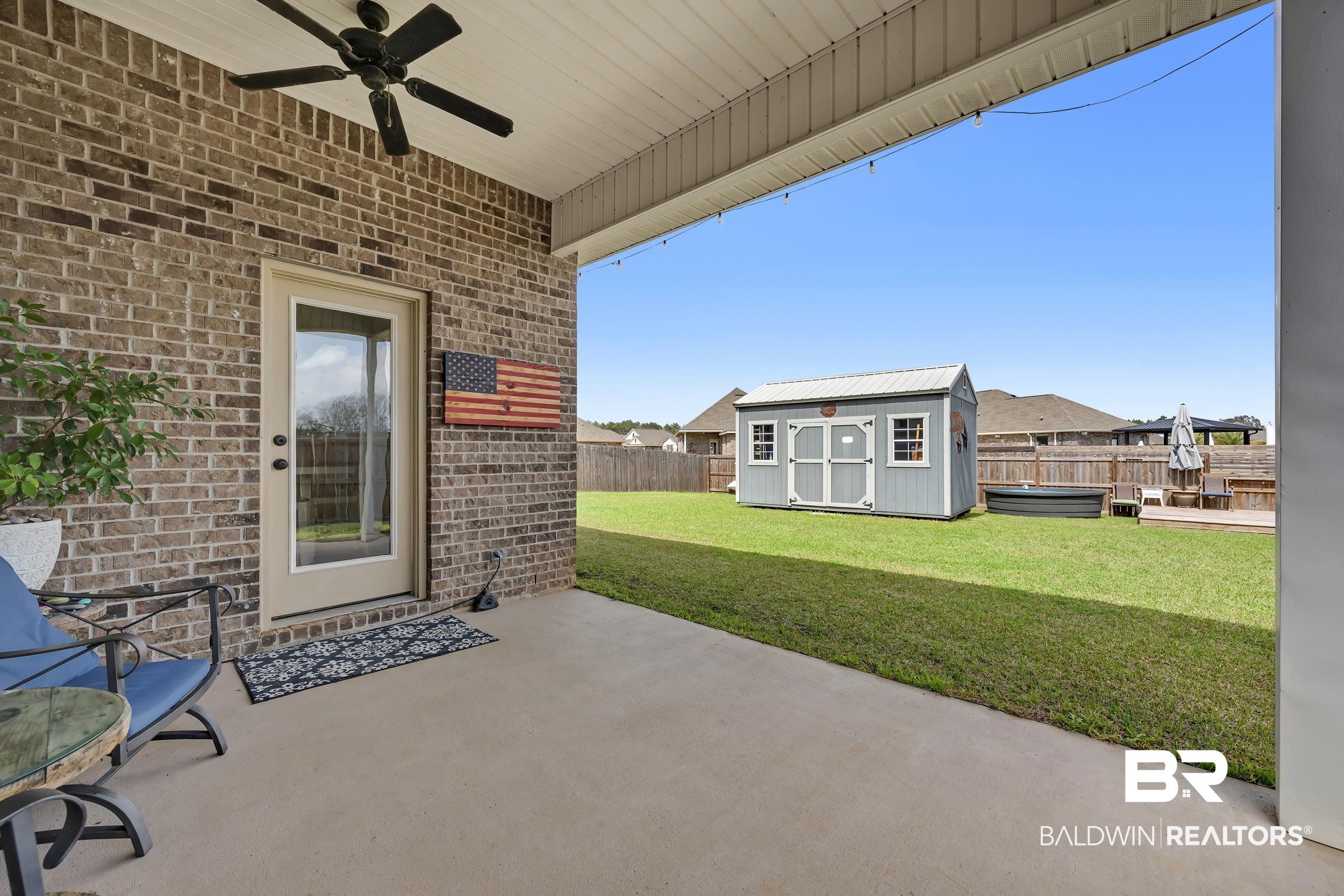 1176 Stella Road Foley, AL 36535 - Photo 38 of 40 Fenced backyard featuring a patio area, ceiling fan, and a storage shed