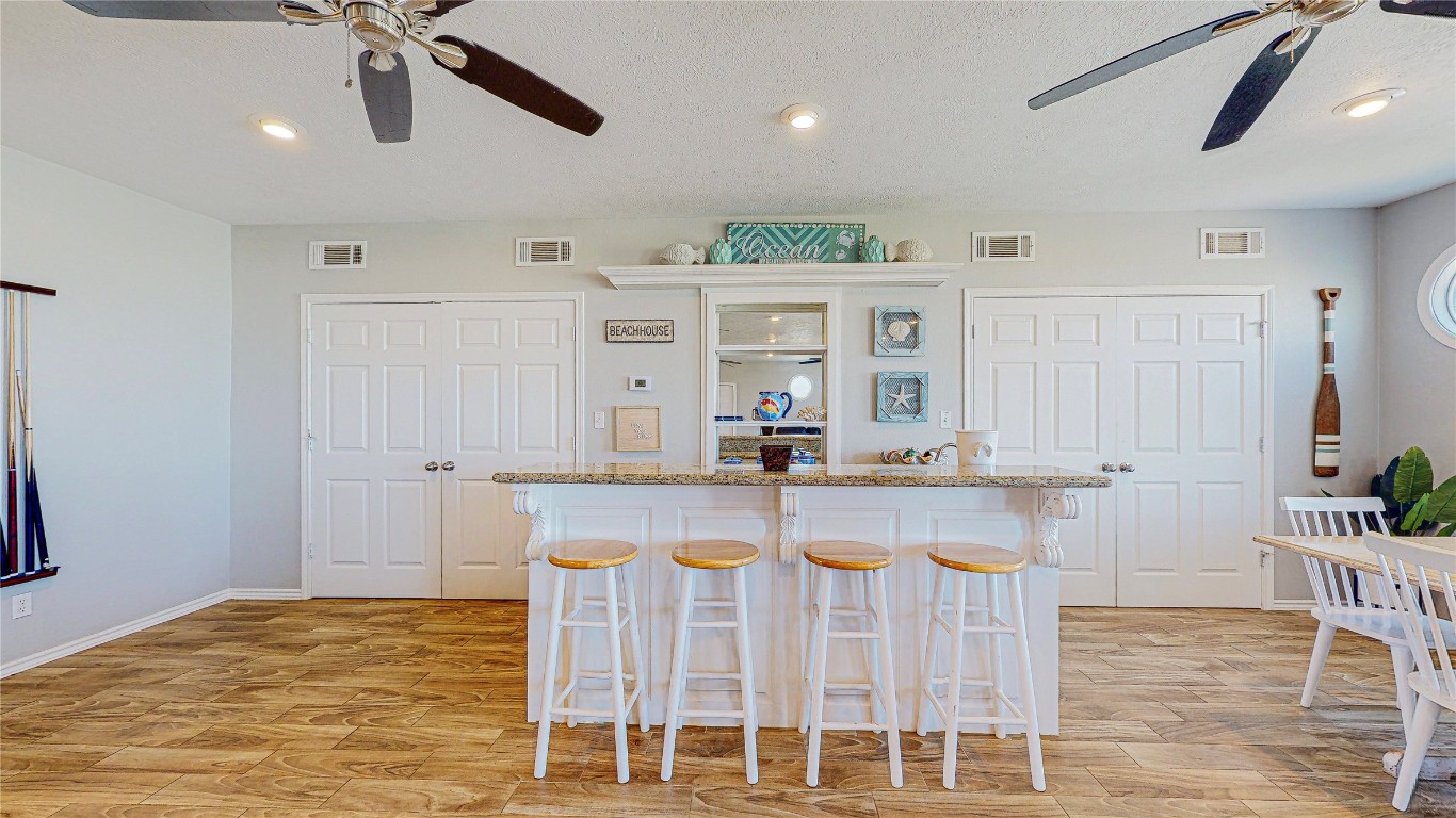 3433 Sand Castle Lane Crystal Beach, TX 77650 - Photo 14 of 30 a kitchen with stainless steel appliances granite countertop a kitchen island a stove and a white cabinets