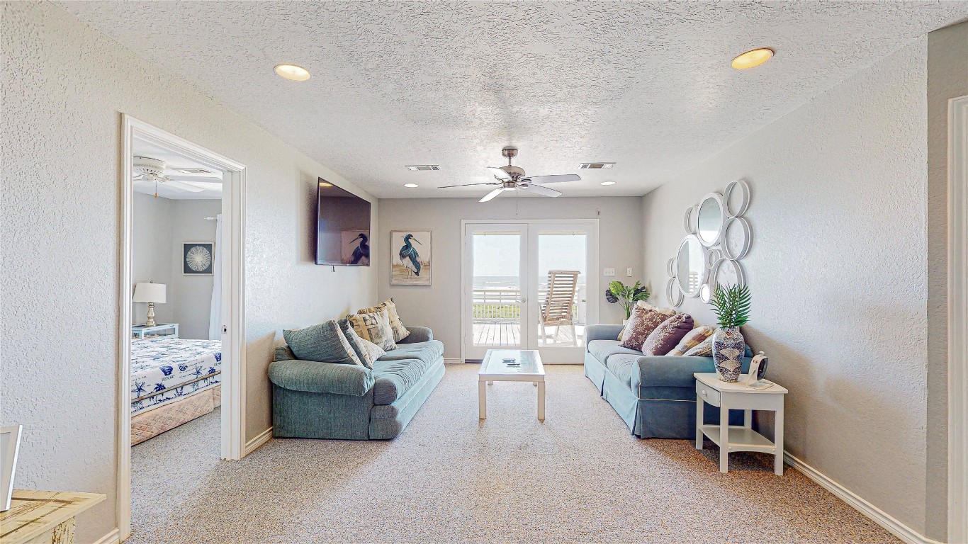 3433 Sand Castle Lane Crystal Beach, TX 77650 - Photo 16 of 30 a living room with furniture and a chandelier