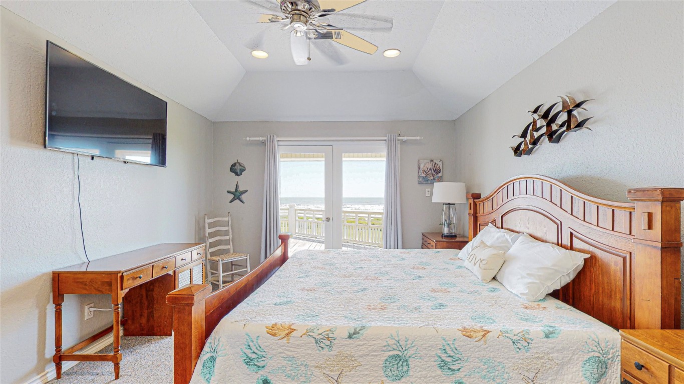3433 Sand Castle Lane Crystal Beach, TX 77650 - Photo 17 of 30 a bedroom with a bed and flat screen tv