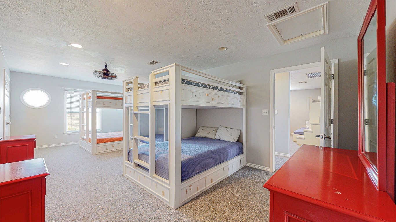 3433 Sand Castle Lane Crystal Beach, TX 77650 - Photo 24 of 30 a bedroom with furniture and a large window