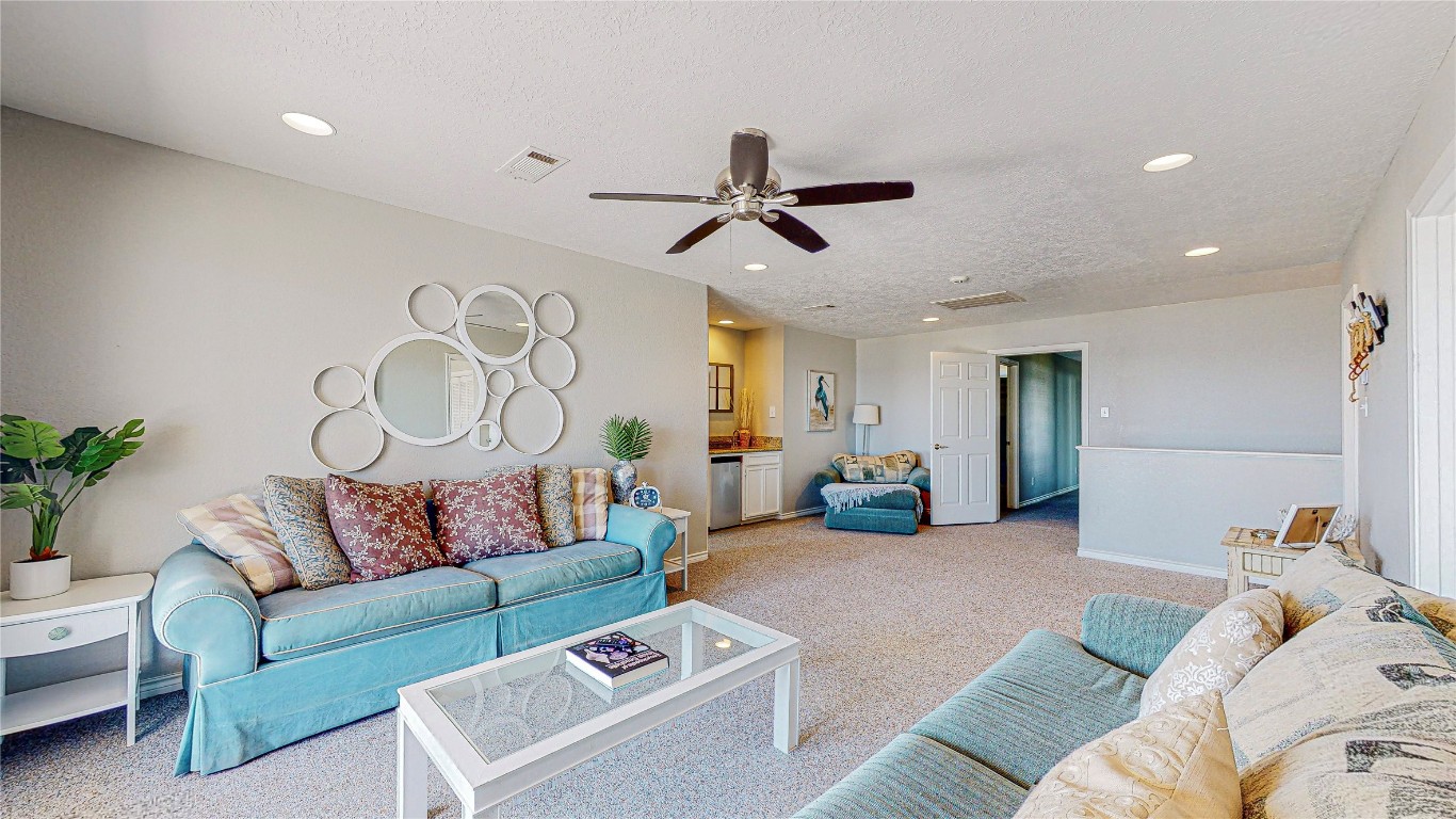 3433 Sand Castle Lane Crystal Beach, TX 77650 - Photo 26 of 30 a living room with furniture and a wooden floor