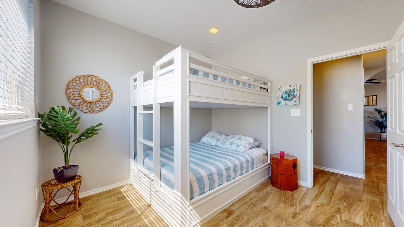 3433 Sand Castle Lane Crystal Beach, TX 77650 - Photo 27 of 30 a bedroom with bed and a mirror