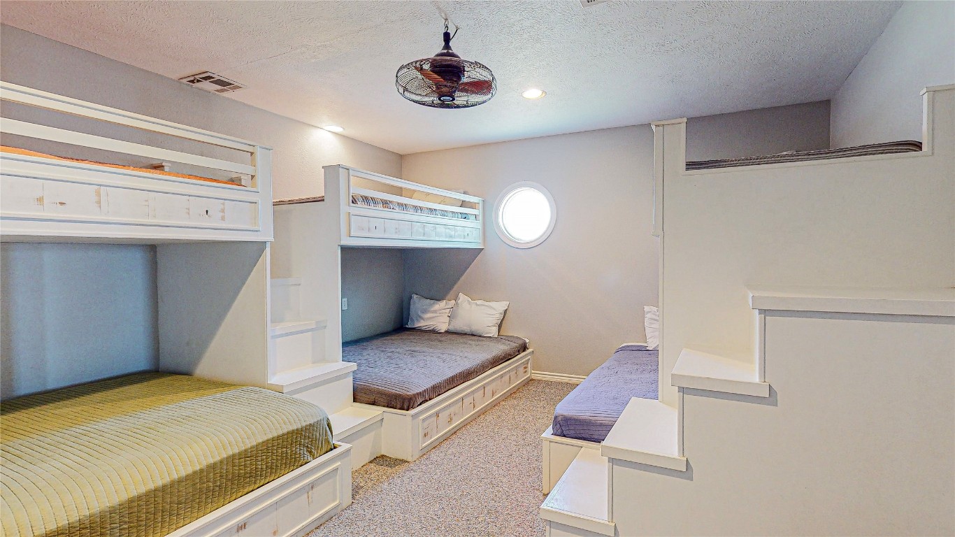3433 Sand Castle Lane Crystal Beach, TX 77650 - Photo 28 of 30 a bedroom with two beds and a chandelier