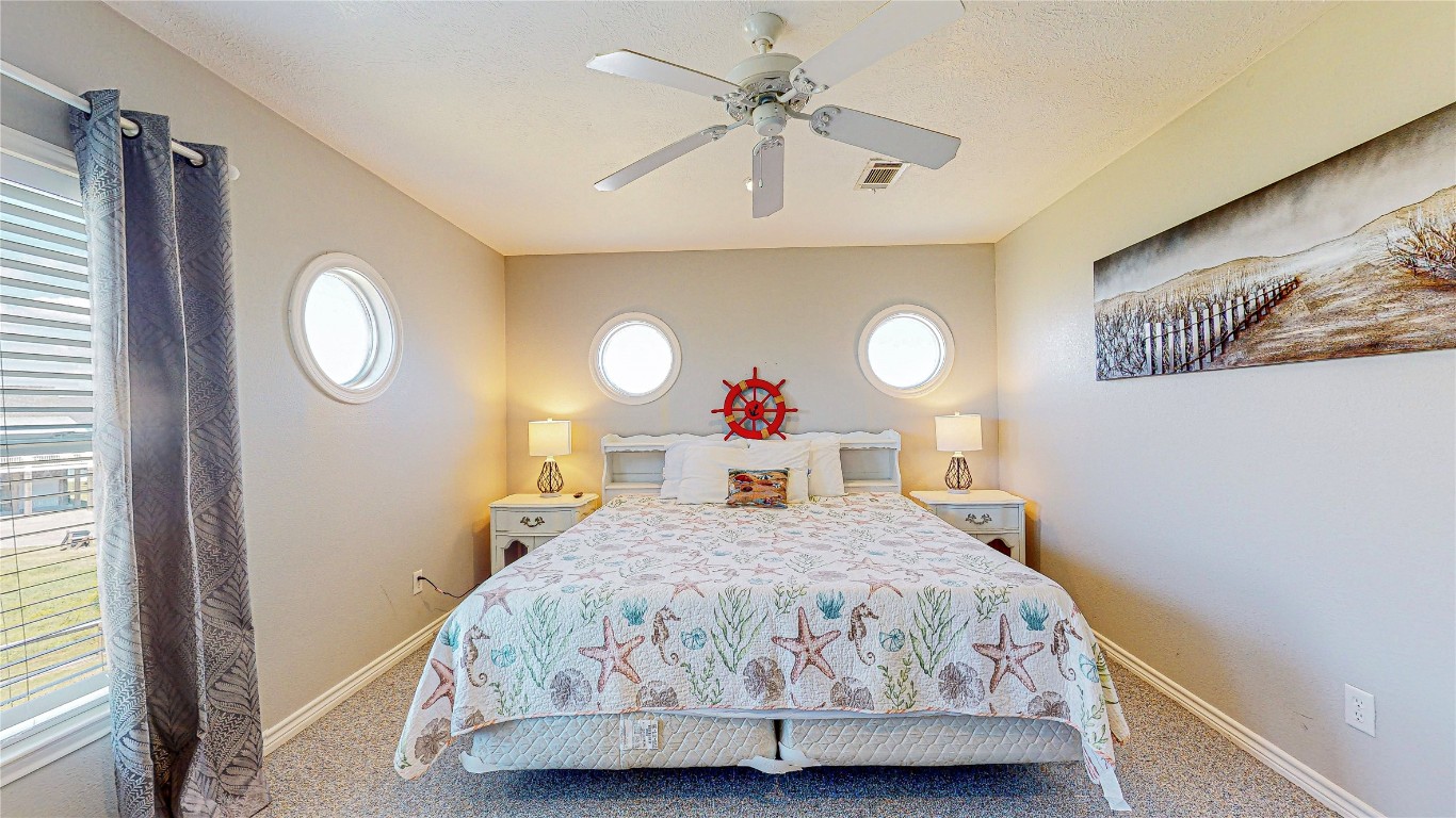 3433 Sand Castle Lane Crystal Beach, TX 77650 - Photo 29 of 30 a bedroom with a bed and a window