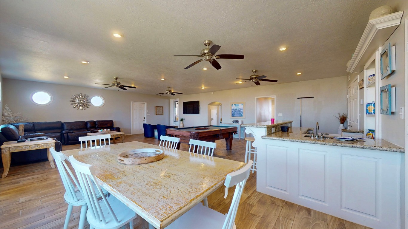 3433 Sand Castle Lane Crystal Beach, TX 77650 - Photo 30 of 30 a view of a dining area with furniture and wooden floor