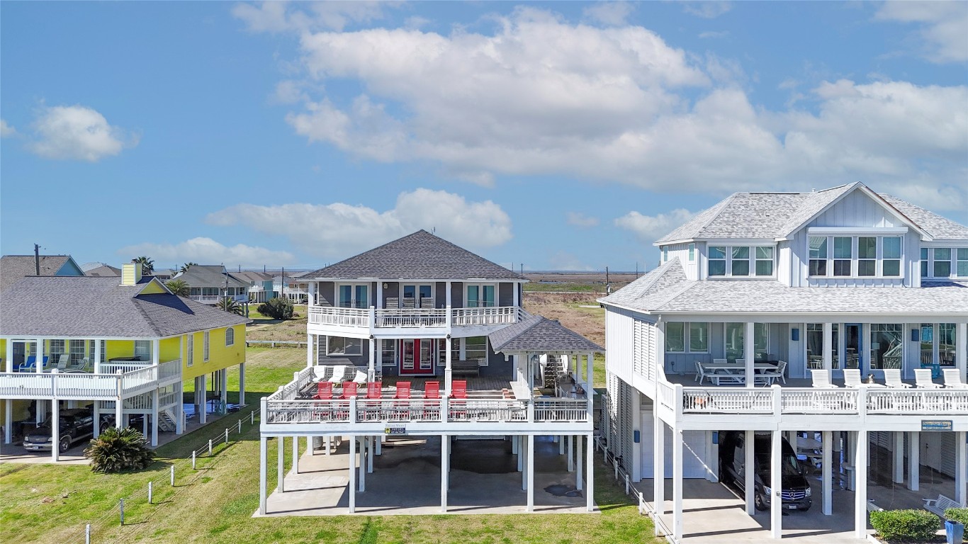 3433 Sand Castle Lane Crystal Beach, TX 77650 - Photo 4 of 30 a front view of a building with a garden