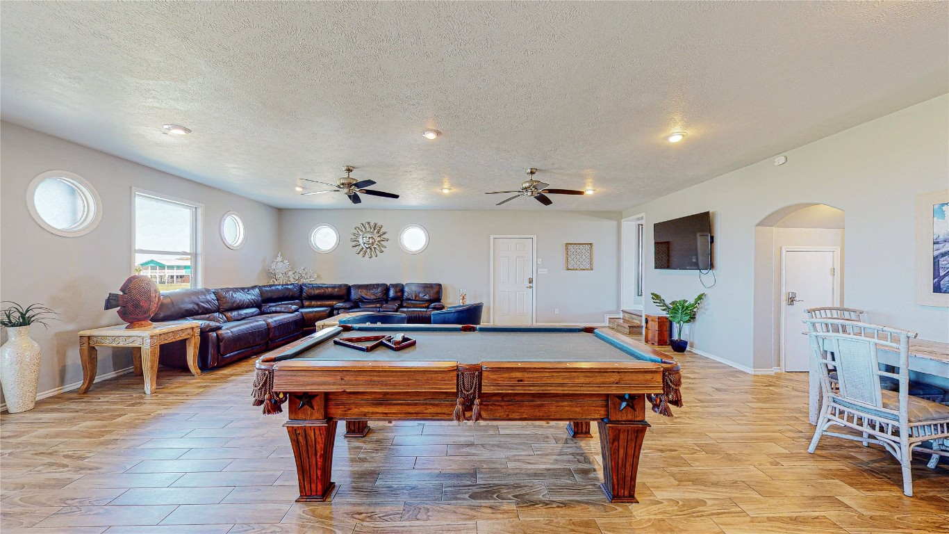 3433 Sand Castle Lane Crystal Beach, TX 77650 - Photo 10 of 30 a room with furniture pool table wooden floor and windows