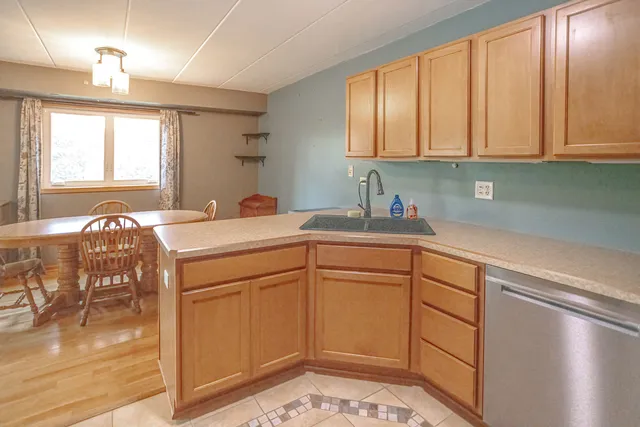 a kitchen with stainless steel appliances granite countertop a sink and cabinets