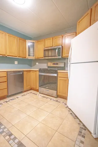 a kitchen with a refrigerator and a sink