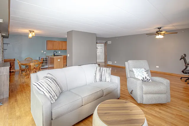 a living room with furniture flowerpot and wooden floor