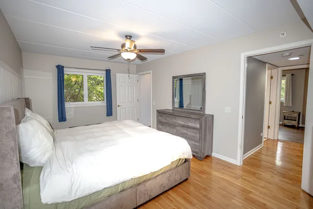 a spacious bedroom with a bed and a chandelier