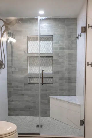 a bathroom with a shower and toilet