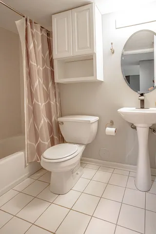 a bathroom with a toilet a sink and bathtub