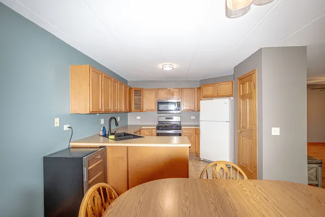 a kitchen with a refrigerator a sink a stove and cabinets