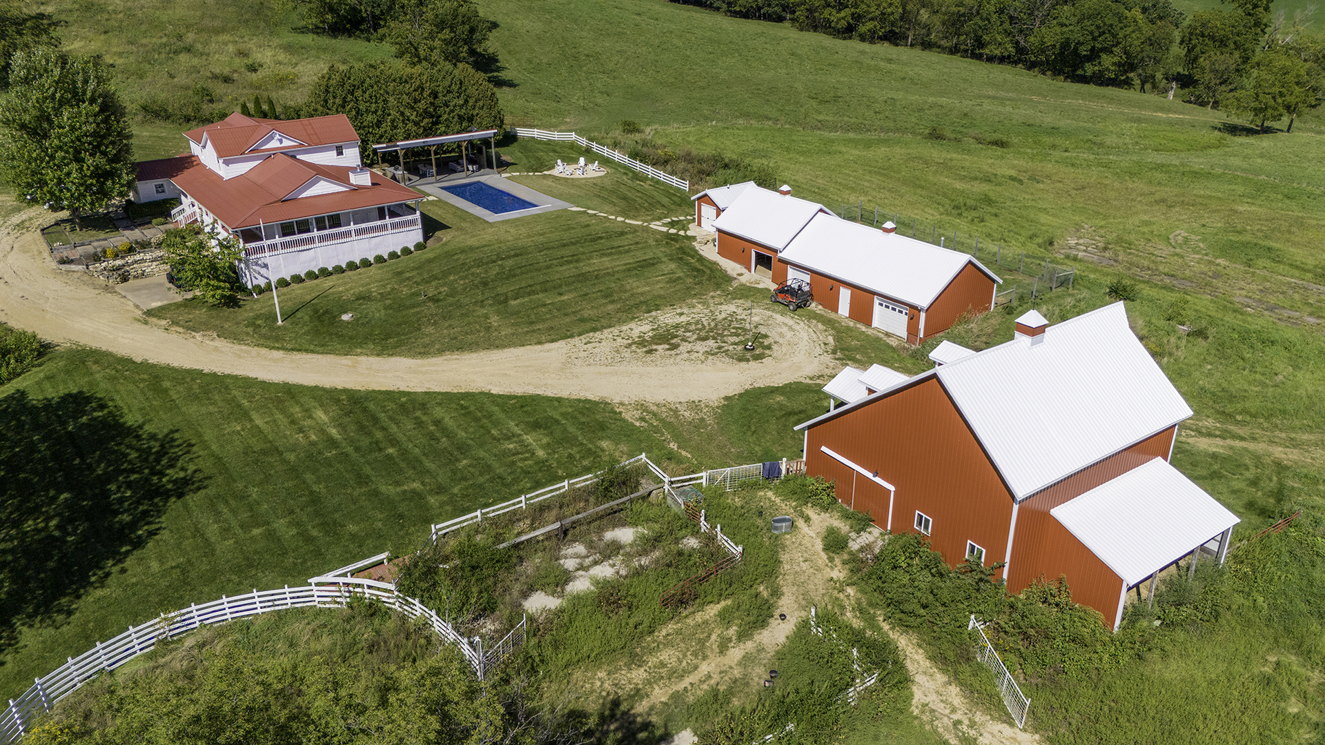 an aerial view of a house with a garden and swimming pool