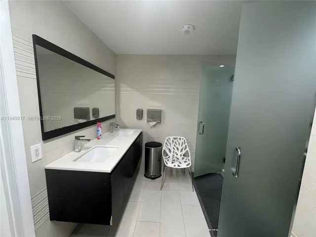 a view of a tall building next to a yard