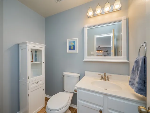 a bathroom with a toilet a sink and a mirror