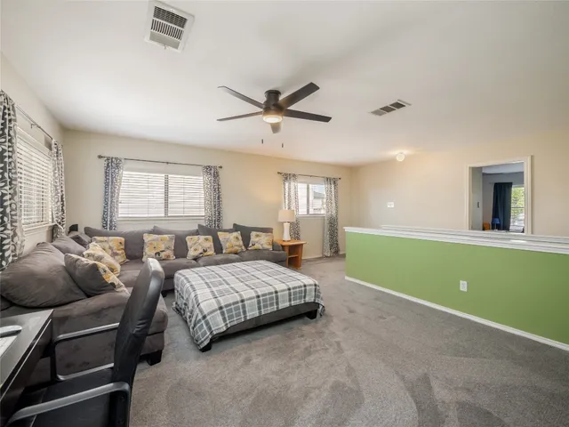 a spacious bedroom with a bed and windows