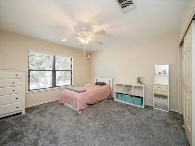 a spacious bedroom with a bed and a window