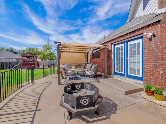 a view of a patio with table and chairs potted plants with wooden fence