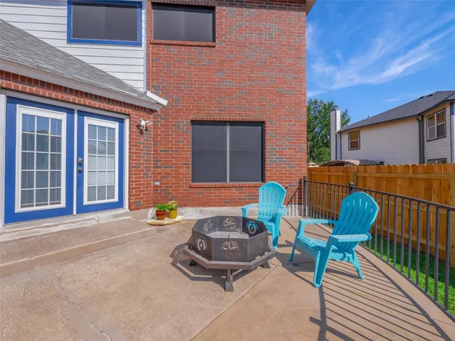 a view of a patio with a chairs and table in a patio