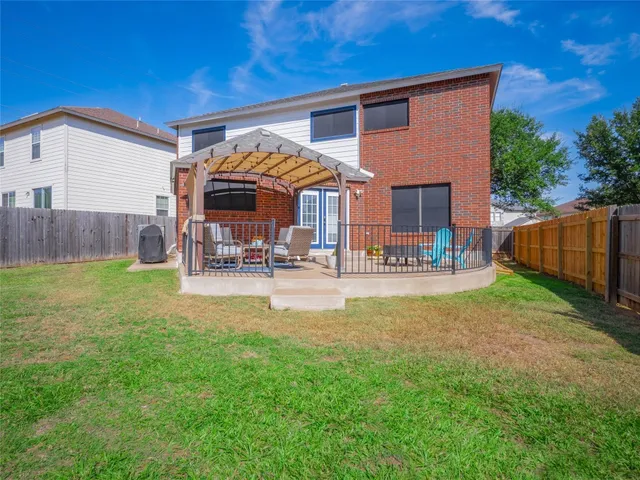 a view of a house with a big yard and sitting area