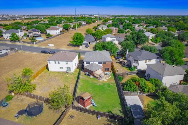 an aerial view of a house with a yard