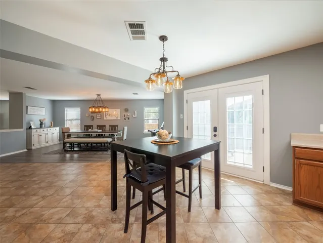 a view of a dining room with furniture and window