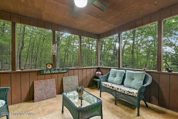 a roof deck with couch and chairs