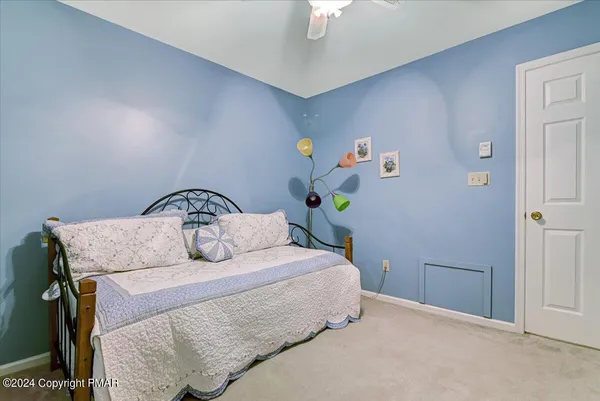 a bedroom with a bed and a chandelier