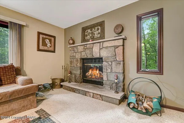 a living room with furniture a window and a fireplace