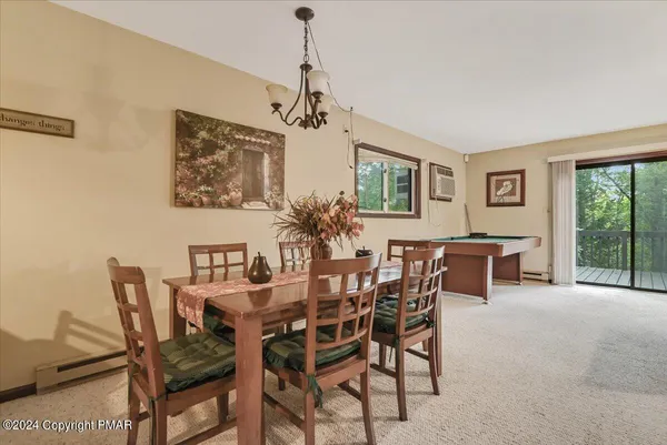 a view of a dining room with furniture and a chandelier