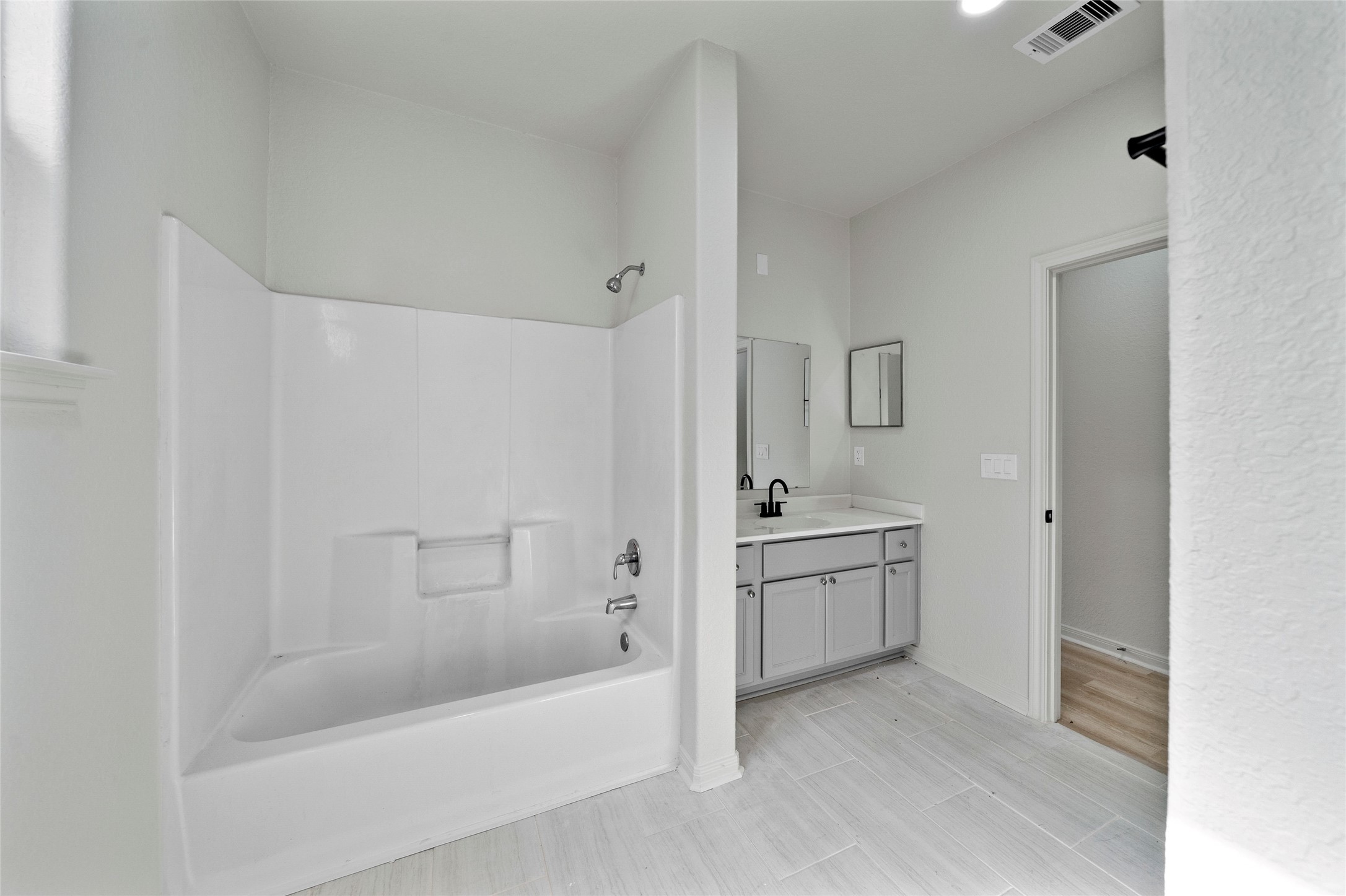 4415 Castor Street Houston, TX 77022 - Photo 14 of 21 a bathroom with a tub sink and mirror