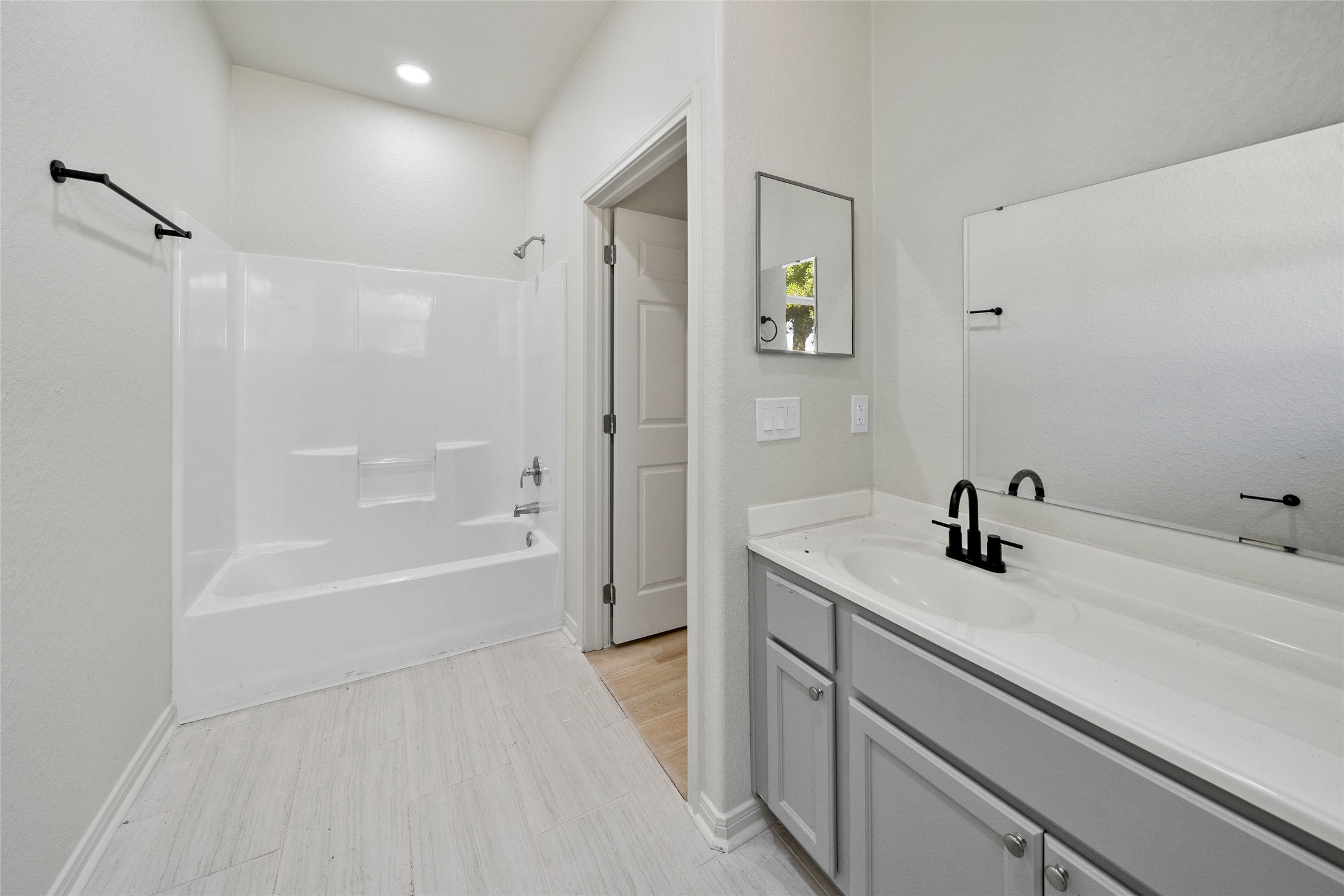 4415 Castor Street Houston, TX 77022 - Photo 20 of 21 a bathroom with a tub sink toilet and a mirror