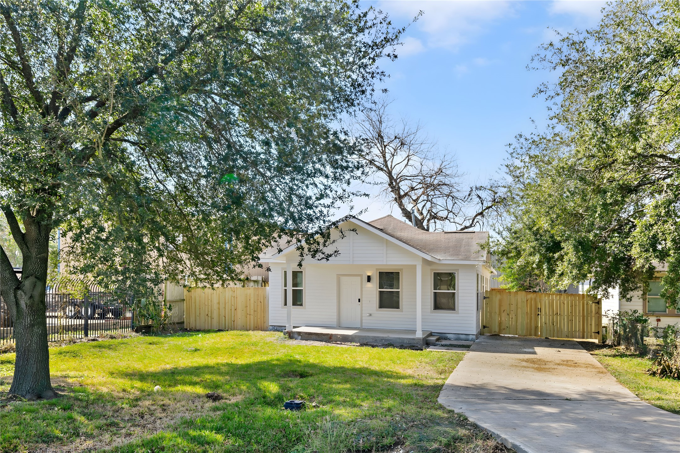 4415 Castor Street Houston, TX 77022 - Photo 2 of 21 a front view of a house with a yard and trees
