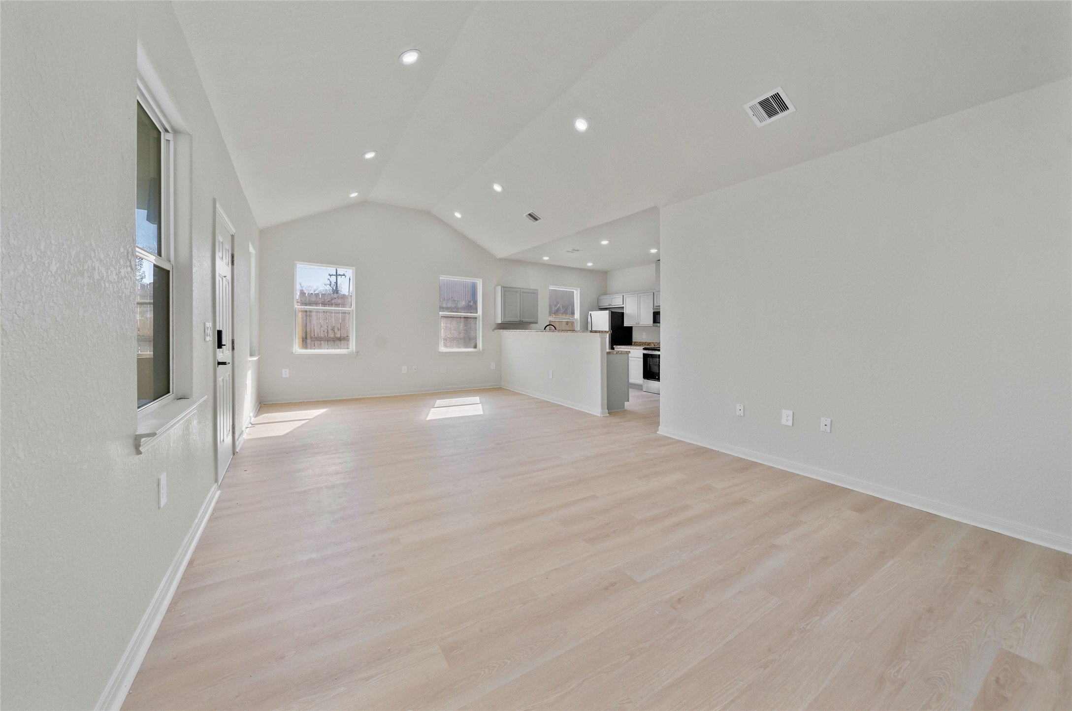 4415 Castor Street Houston, TX 77022 - Photo 5 of 21 a view of a big room with wooden floor and windows