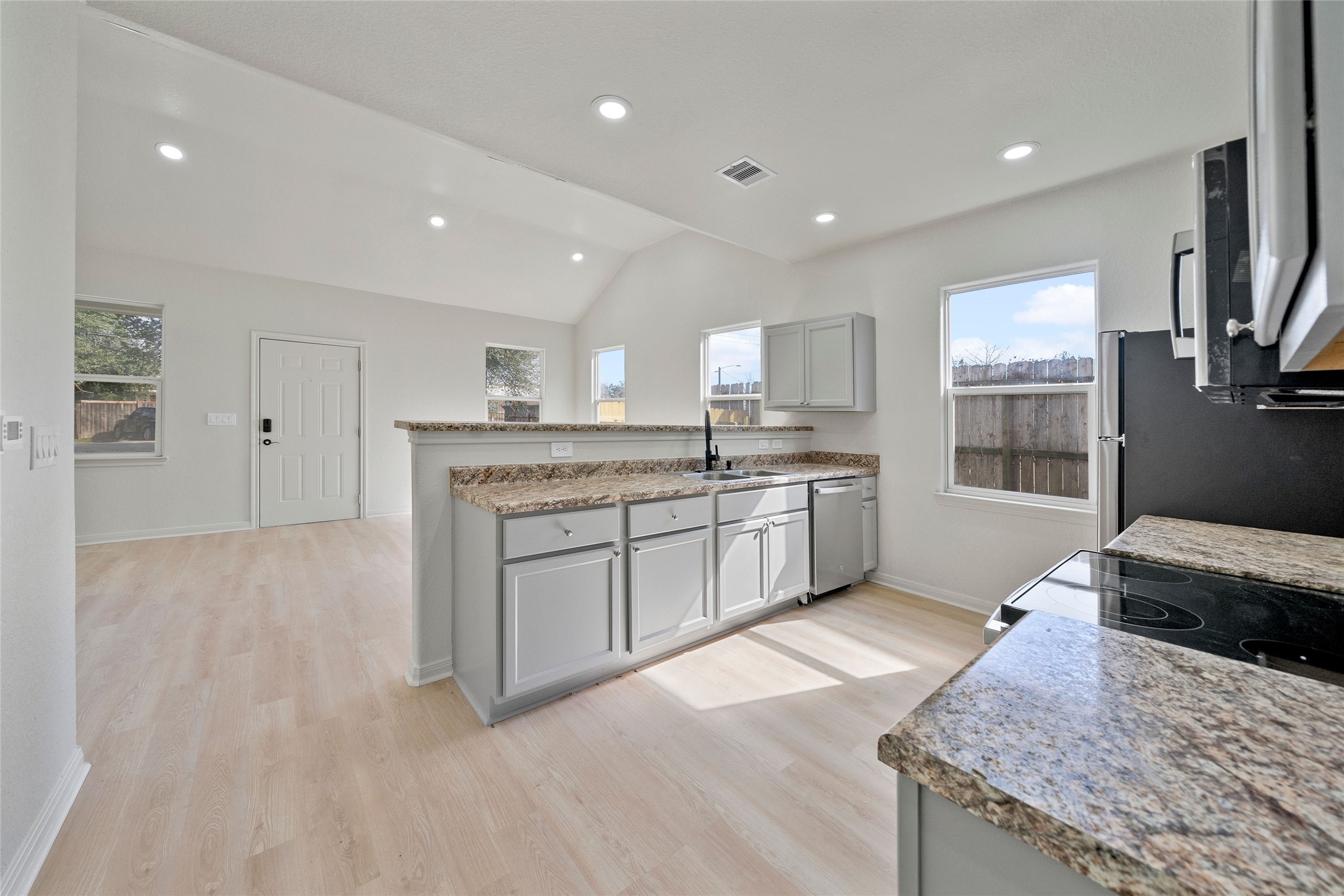 4415 Castor Street Houston, TX 77022 - Photo 6 of 21 a large kitchen with stainless steel appliances granite countertop a stove a sink and a granite counter tops