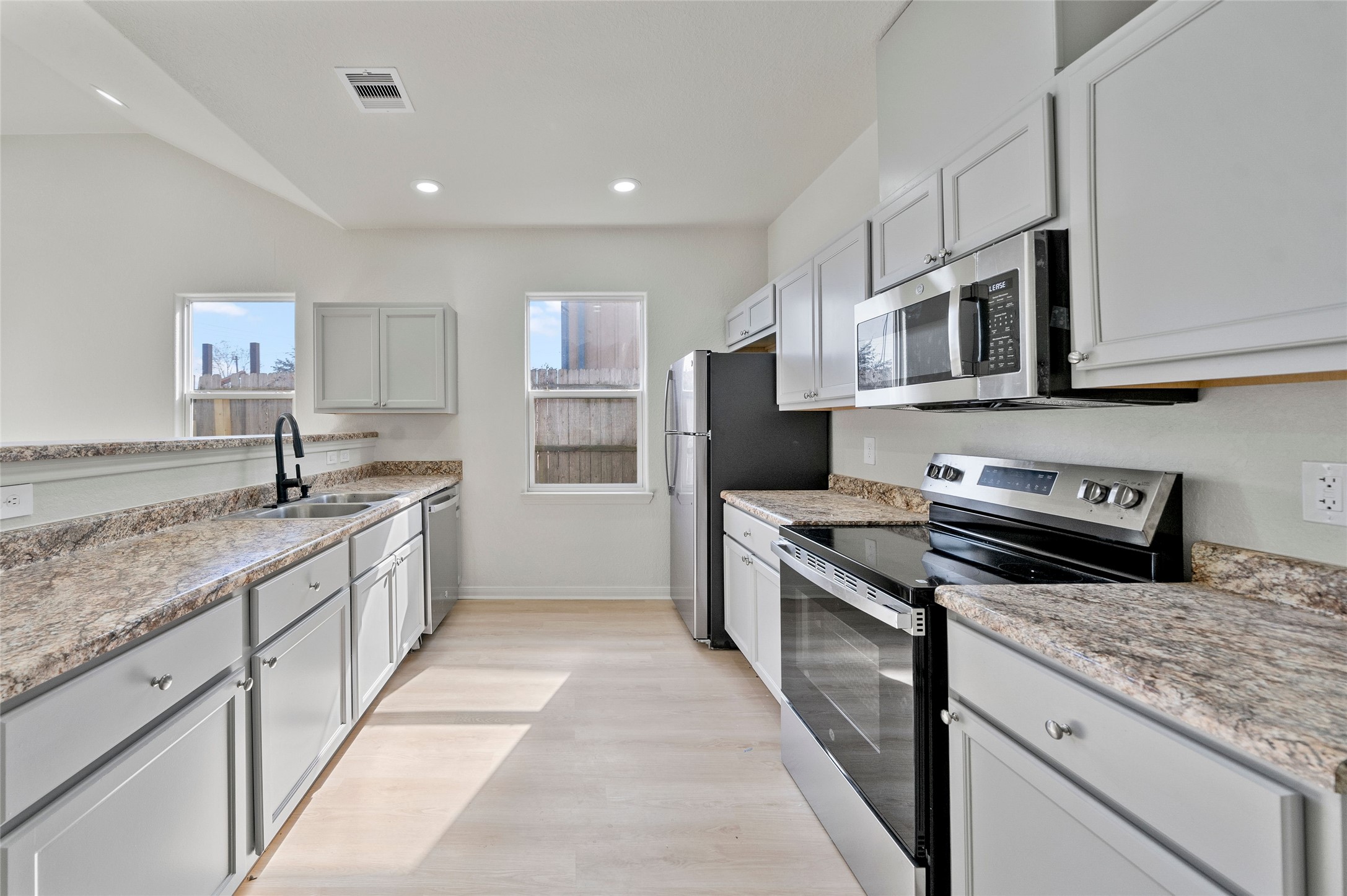 4415 Castor Street Houston, TX 77022 - Photo 7 of 21 a kitchen with stainless steel appliances granite countertop a stove top oven a sink and dishwasher