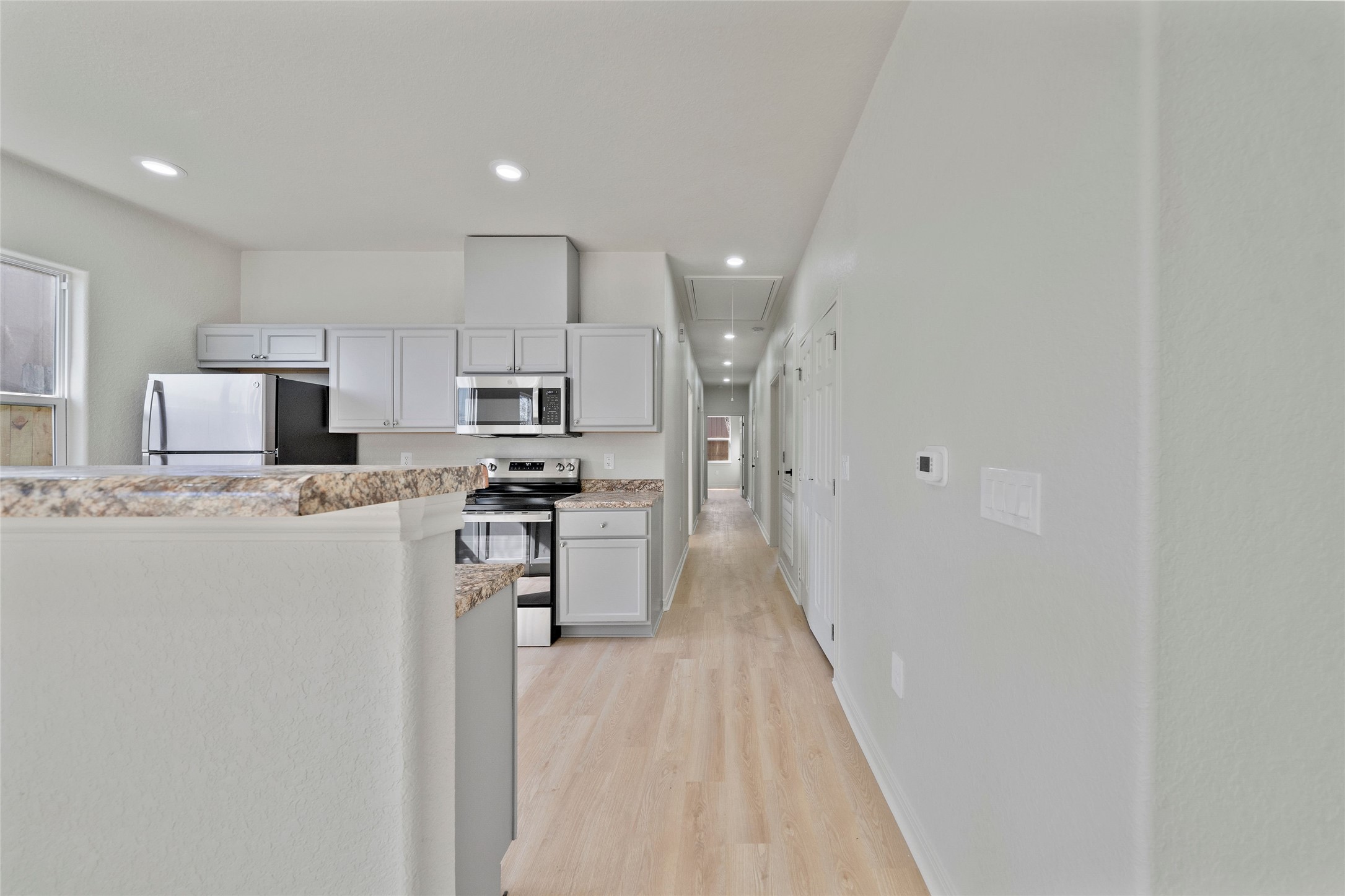 4415 Castor Street Houston, TX 77022 - Photo 9 of 21 a kitchen with cabinets and stainless steel appliances