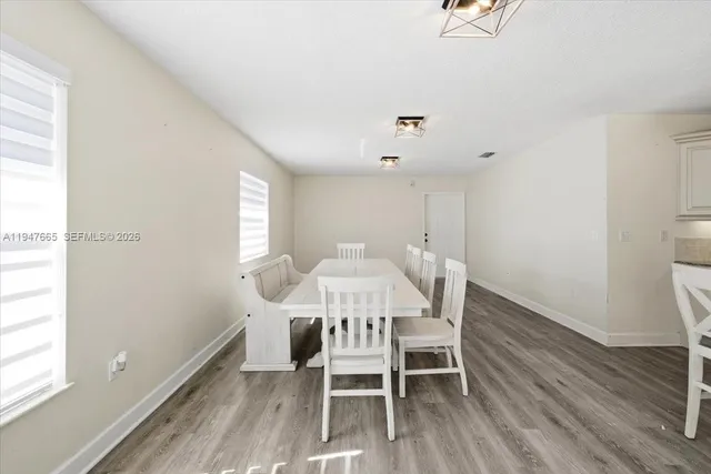 a view of a dining room with furniture and wooden floor