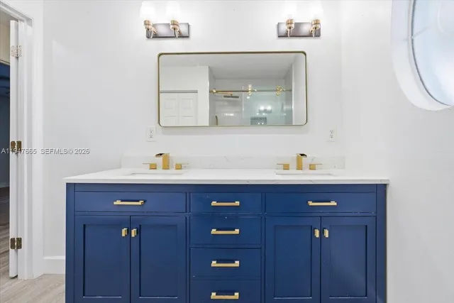 a bathroom with a sink vanity and mirror