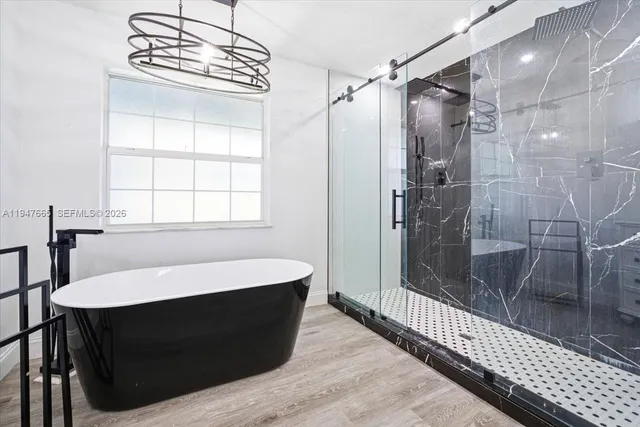 a bathroom with a sink a bathtub and a shower