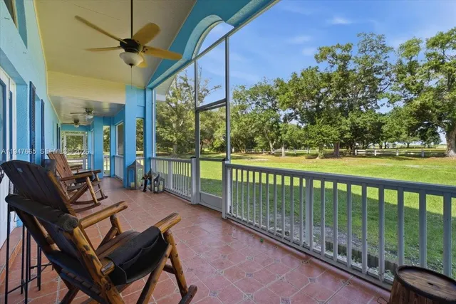 a view of a patio with a table chairs and a backyard