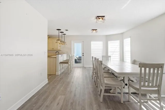 a dining room with furniture and wooden floor