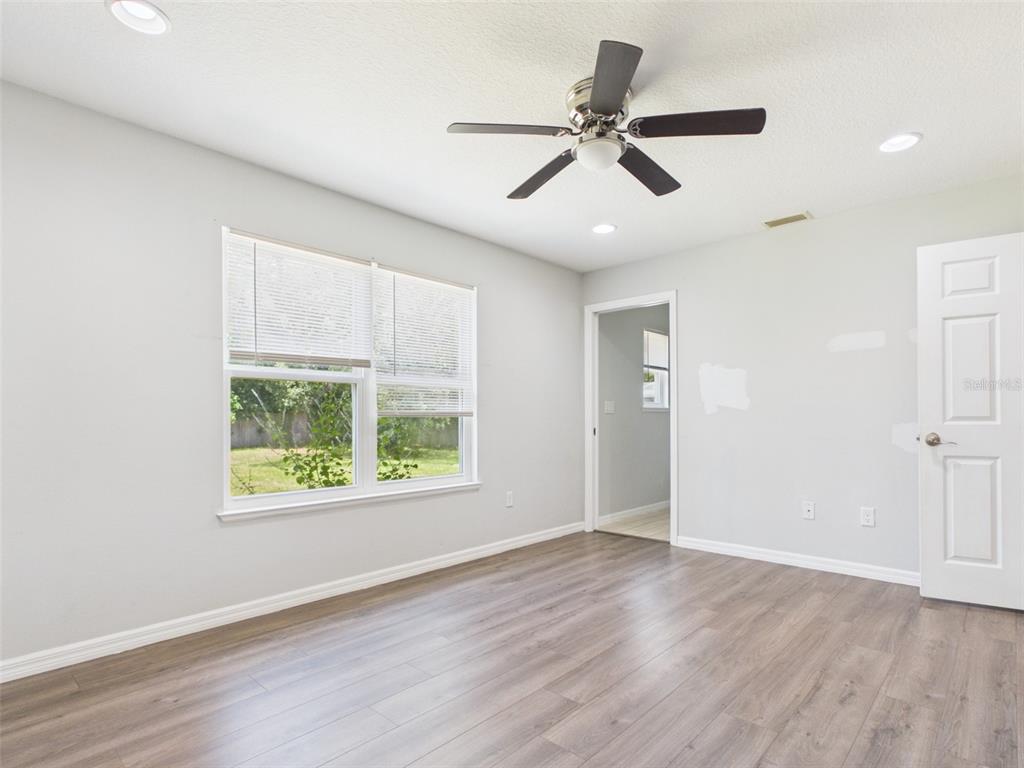 4309 Southwest 143rd Ln Road Ocala, FL 34473 - Photo 15 of 21 a view of an empty room with wooden floor and a window