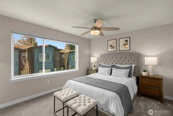 a bedroom with a large bed and a window